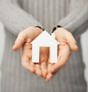 man holding paper house