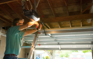 man maintaining his garage door